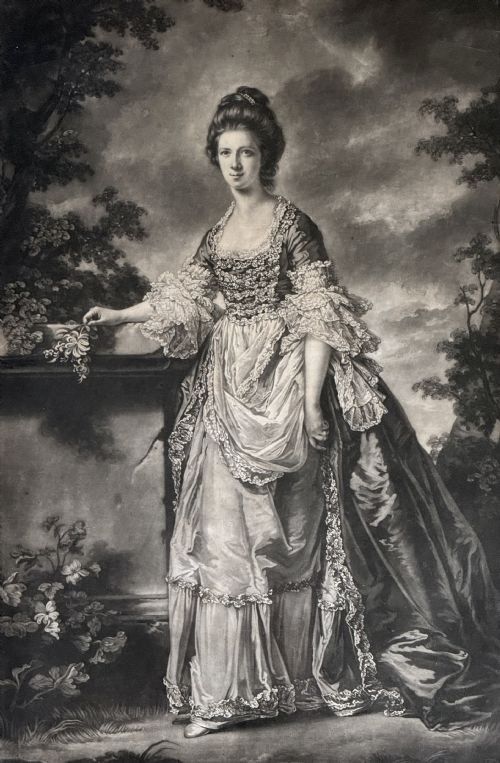 fig 1. A framed 18th-century monochrome mezzotint portrait depicting a woman in formal period dress standing beside a stone pedestal in a black frame with a gilt inner border.