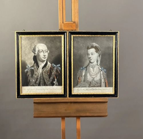 fig 2. A framed pair of 18th-century monochrome mezzotint portraits depicting King George III and Queen Charlotte in decorative ebonised and gilt wood frames.