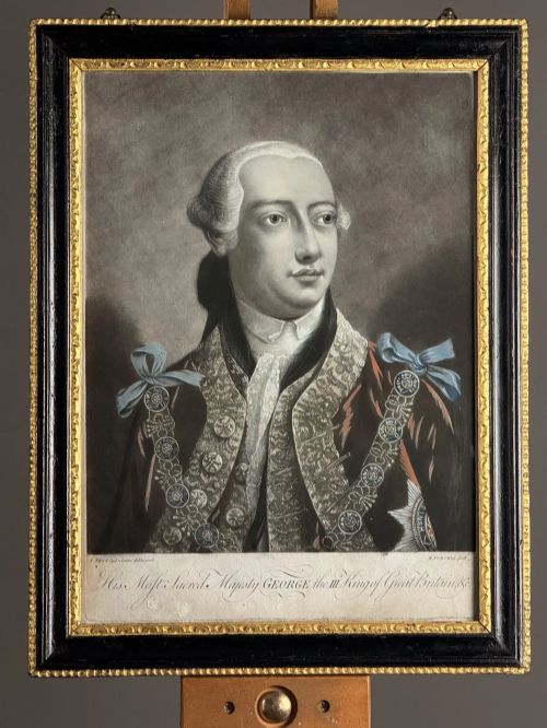 fig 3. A framed pair of 18th-century monochrome mezzotint portraits depicting King George III and Queen Charlotte in decorative ebonised and gilt wood frames.