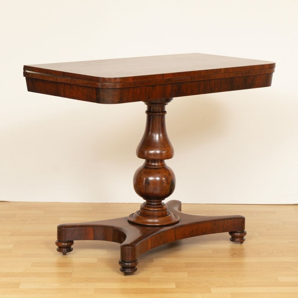 A Regency rosewood card table featuring a fold-over top, turned pedestal column, and quadripartite platform base on turned feet. View III
