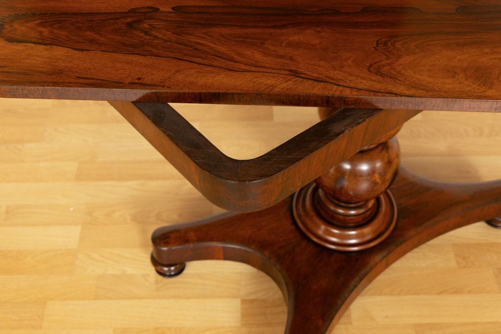 A Regency rosewood card table featuring a fold-over top, turned pedestal column, and quadripartite platform base on turned feet. View IV