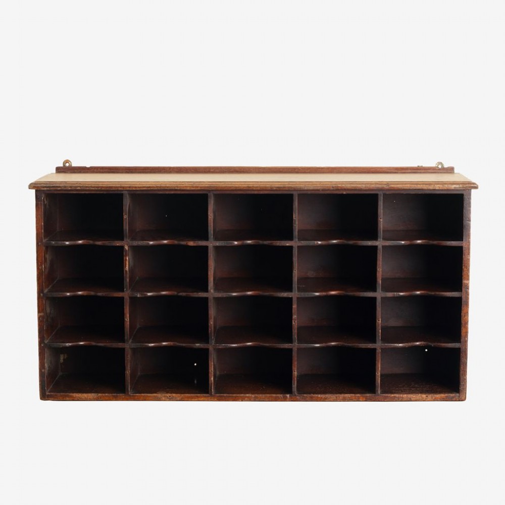 A 19th-century dark mahogany desktop pigeon hole unit featuring twenty-four open rectangular compartments with contoured shelf edges. View II