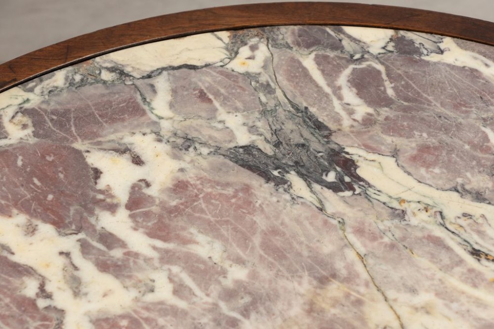 A round French walnut coffee table featuring a variegated pink and cream marble top, carved egg-and-dart moulding, and cabriole legs ending in claw-and-ball feet. View III