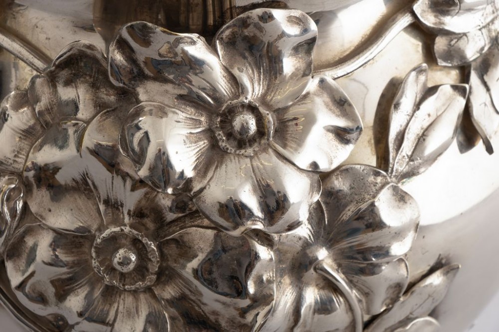 A silver-plated Art Nouveau champagne bucket featuring floral relief details, whiplash tendrils, sculpted handles with female heads, and a pierced footed base. View IV