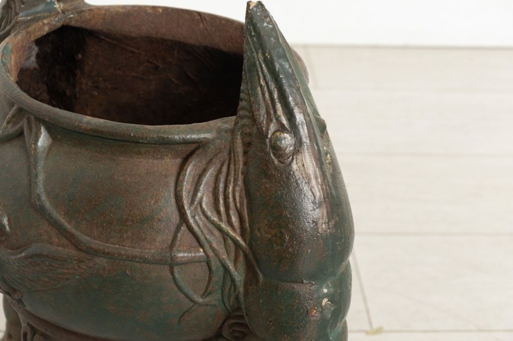 A pair of dark green cast iron planters designed as rounded vessels supported by three carved shrimp legs with relief bird motifs. View IV
