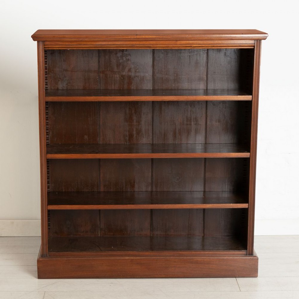 A Victorian walnut open bookcase featuring three adjustable shelves, fluted side pilasters, and a solid plinth base. View II