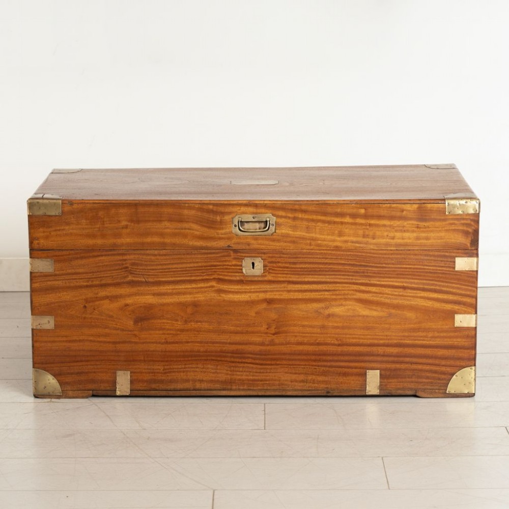 A warm brown rectangular camphor wood campaign chest featuring flush brass corner brackets, recessed carrying handles, and a flat hinged lid. View II