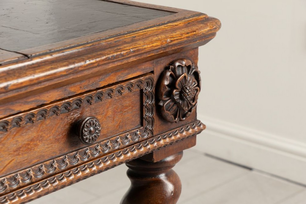 A nineteenth-century dark oak Neo-Jacobean architect desk with barley twist legs, carved decorative frieze, and an adjustable central leather writing slope. View IV
