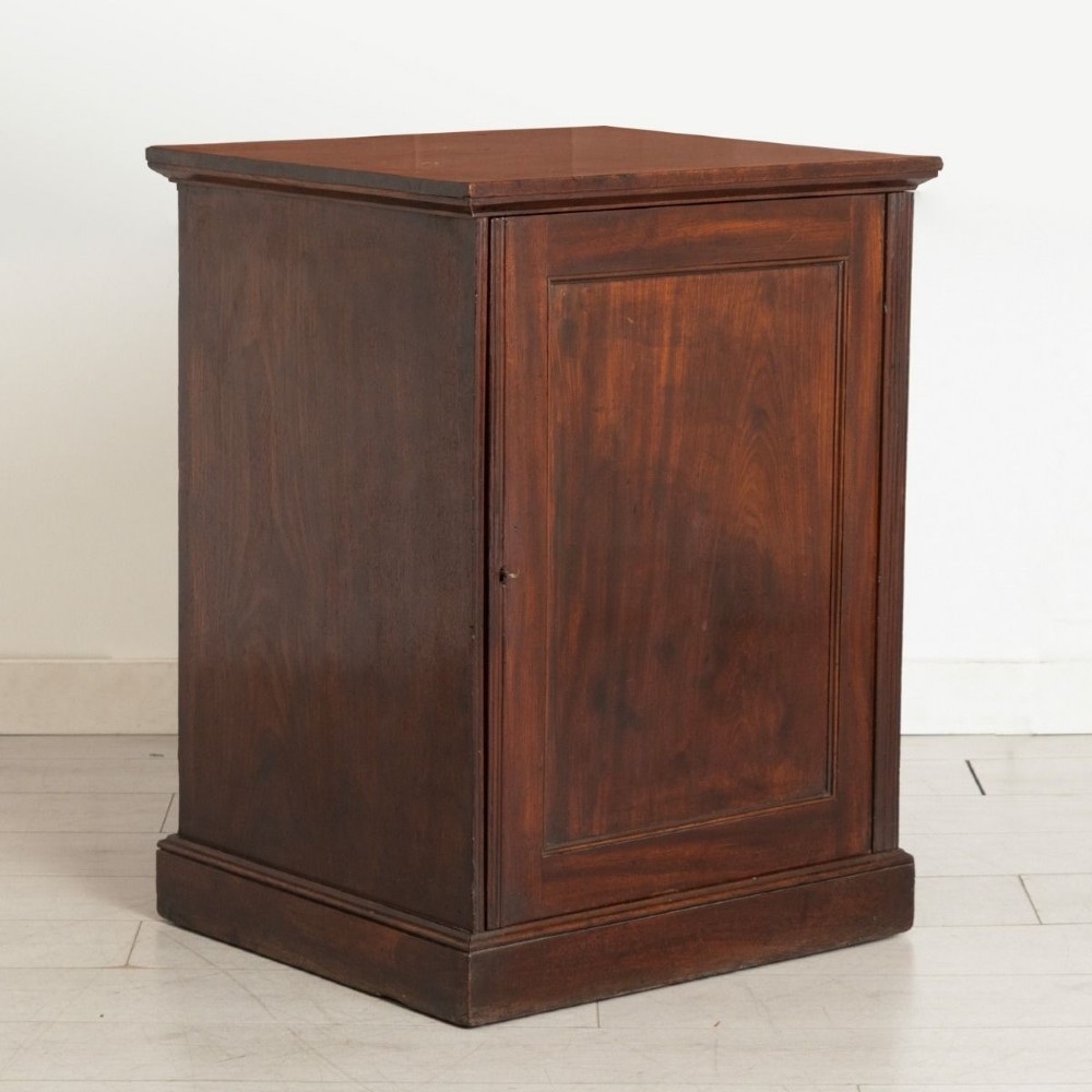 A dark mahogany musicians cabinet with an open single panel door revealing five shallow drawers with turned circular knobs. View II