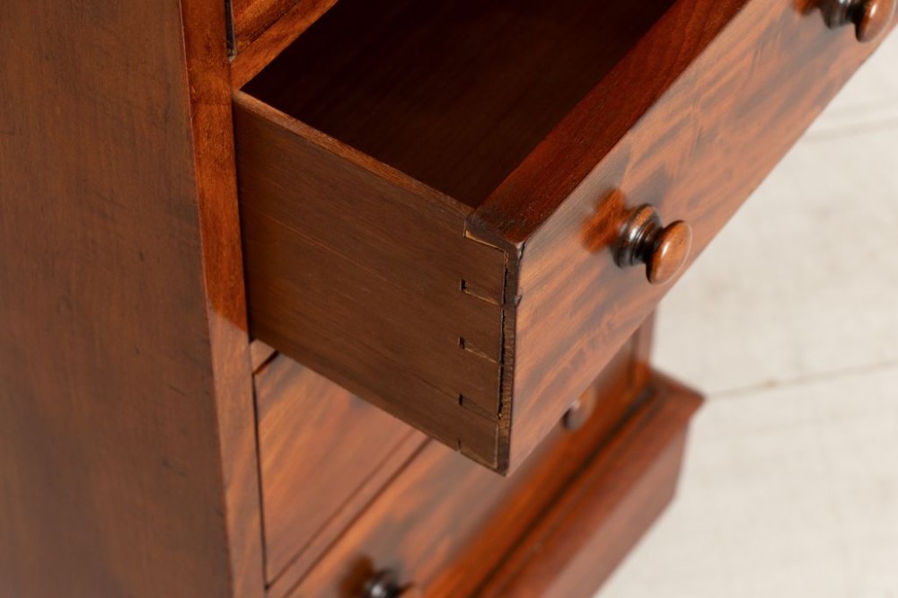 A matching pair of 19th-century Victorian mahogany bedside chests, each featuring four drawers with turned wooden handles and a plinth base. View II