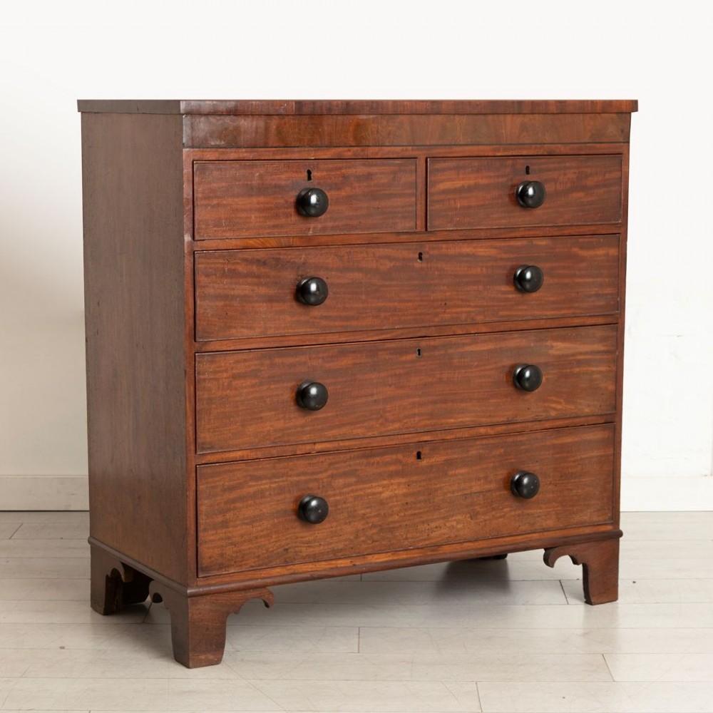 Victorian mahogany chest of drawers featuring two short drawers over three long drawers with dark turned knobs and shaped bracket feet. View II