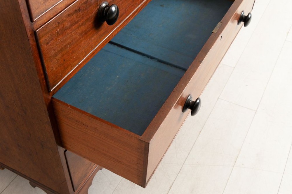 Victorian mahogany chest of drawers featuring two short drawers over three long drawers with dark turned knobs and shaped bracket feet. View III