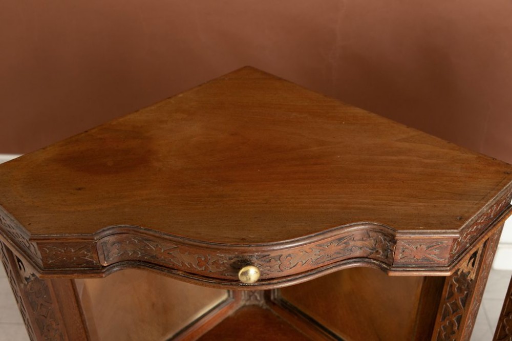 A pair of late 19th-century mahogany corner display cabinets featuring mirrored back panels, carved open shelves, and turned legs. View III