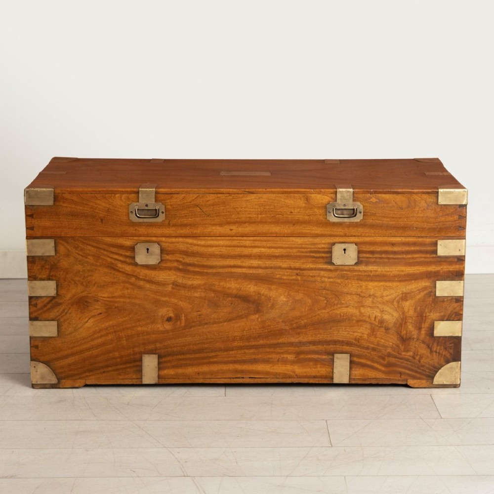 A nineteenth-century brass-bound camphor wood military campaign chest featuring flush brass corner brackets, dual locks, and side carrying handles. View II
