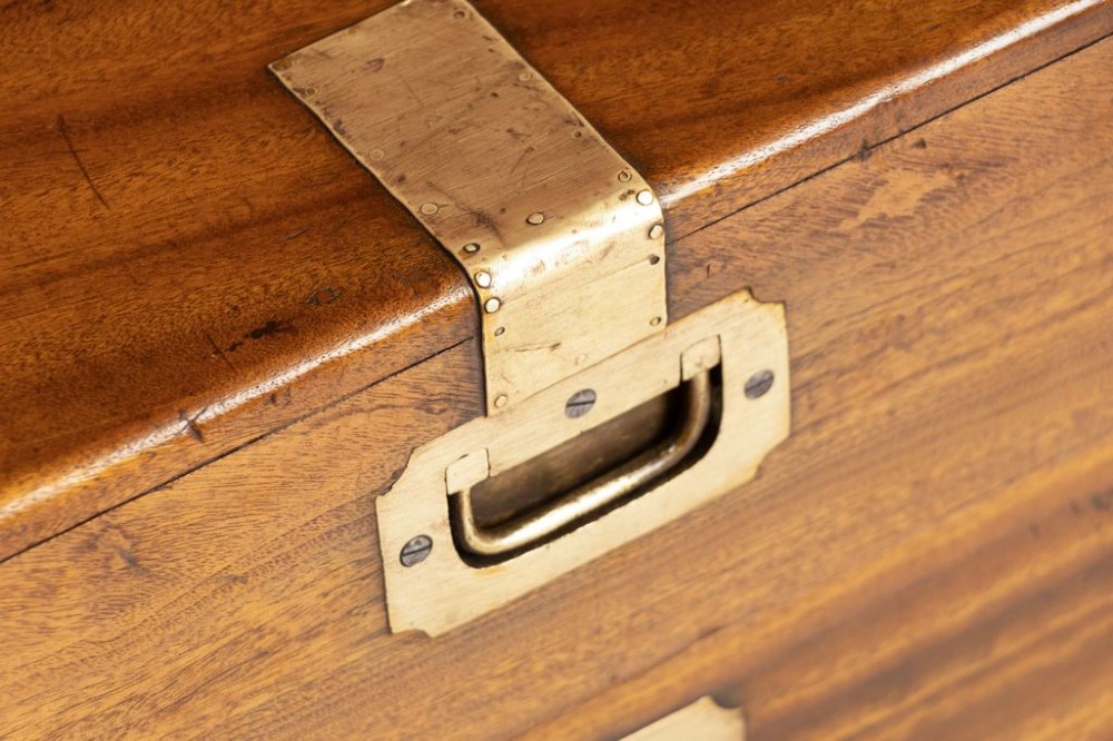 A nineteenth-century brass-bound camphor wood military campaign chest featuring flush brass corner brackets, dual locks, and side carrying handles. View III