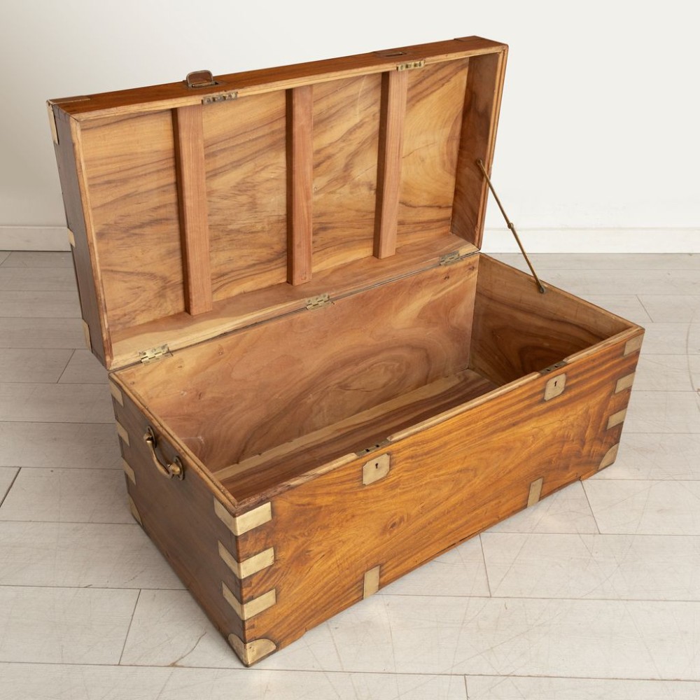 A nineteenth-century brass-bound camphor wood military campaign chest featuring flush brass corner brackets, dual locks, and side carrying handles. View IV