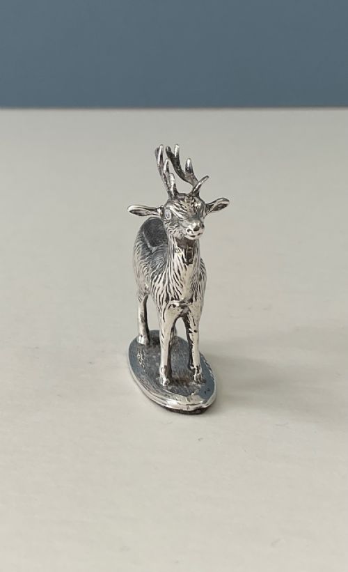 fig 1. A hallmarked sterling silver pin cushion modelled in the form of a standing stag with antlers on an oval base.