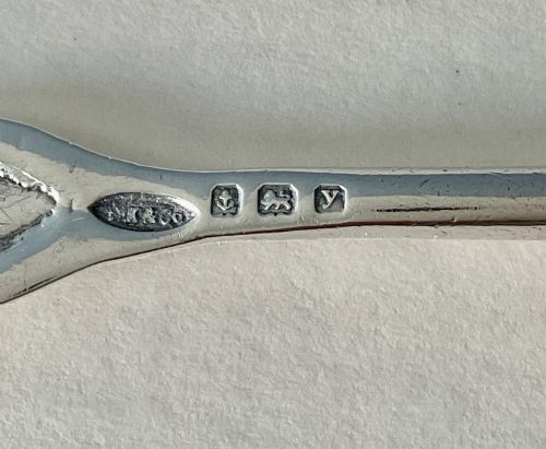 fig 2. An Arts and Crafts sterling silver caddy spoon featuring a hand-hammered bowl and an intertwined stem handle.
