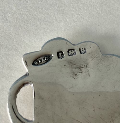 fig 2. A hand-hammered silver caddy spoon featuring a stylized profile head handle and a teardrop-shaped planished bowl.