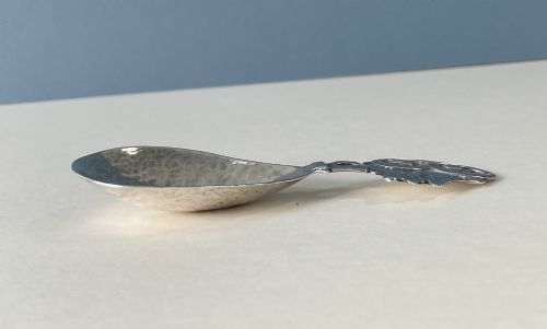 fig 3. A hand-hammered silver caddy spoon featuring a stylized profile head handle and a teardrop-shaped planished bowl.