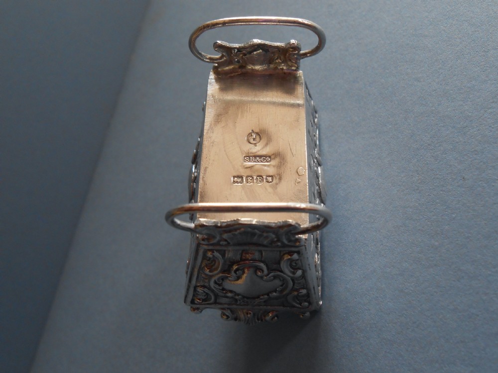 An Edwardian silver novelty snuff box crafted in the form of a miniature wicker cradle with a sleeping infant figure on the hinged lid. View VII