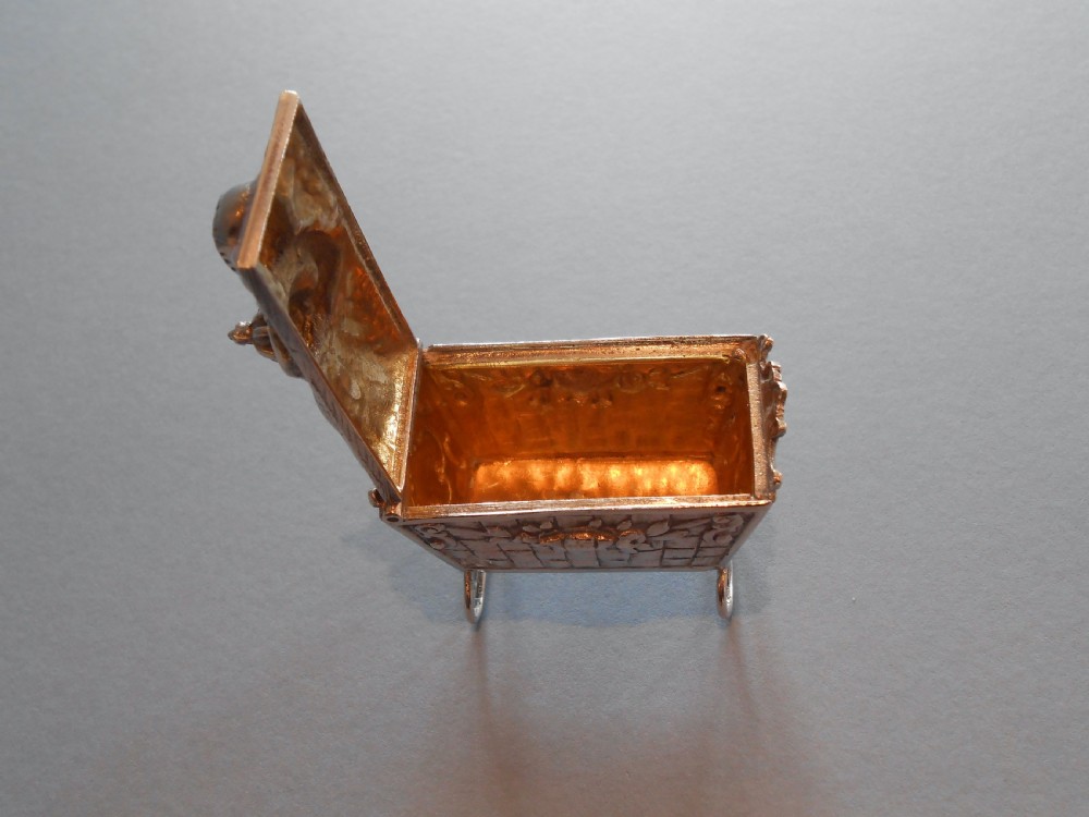 An Edwardian silver novelty snuff box crafted in the form of a miniature wicker cradle with a sleeping infant figure on the hinged lid. View VIII