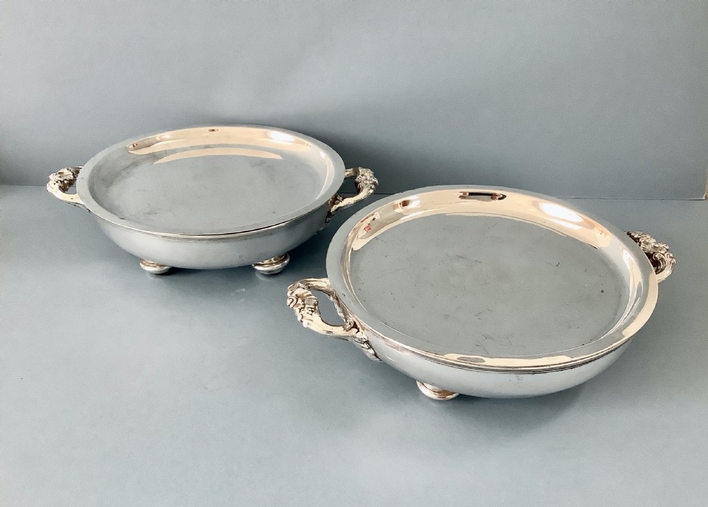 A pair of antique Georgian Old Sheffield Plate oval warming dishes with twin side handles and turned feet. View II