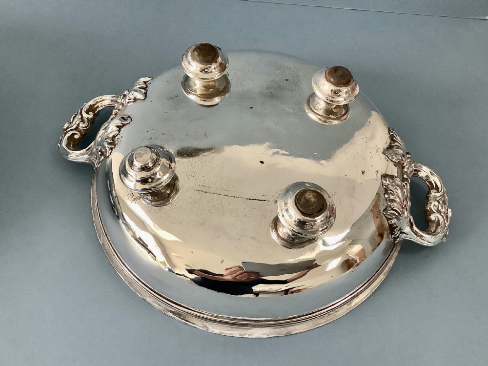 A pair of antique Georgian Old Sheffield Plate oval warming dishes with twin side handles and turned feet. View VI