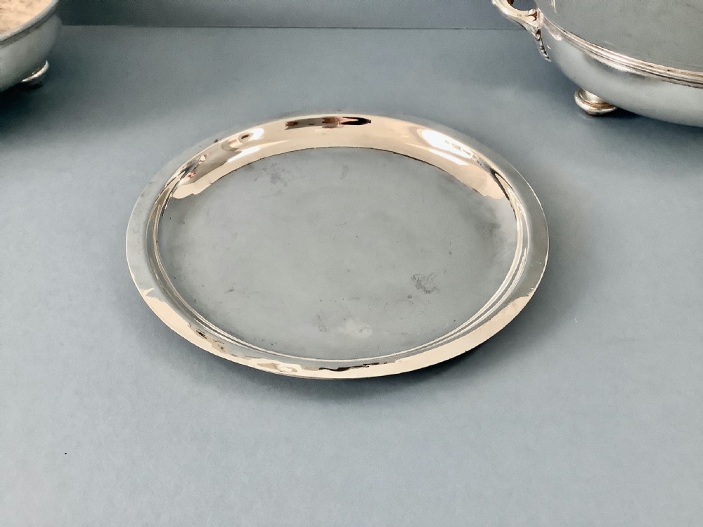 A pair of antique Georgian Old Sheffield Plate oval warming dishes with twin side handles and turned feet. View VII