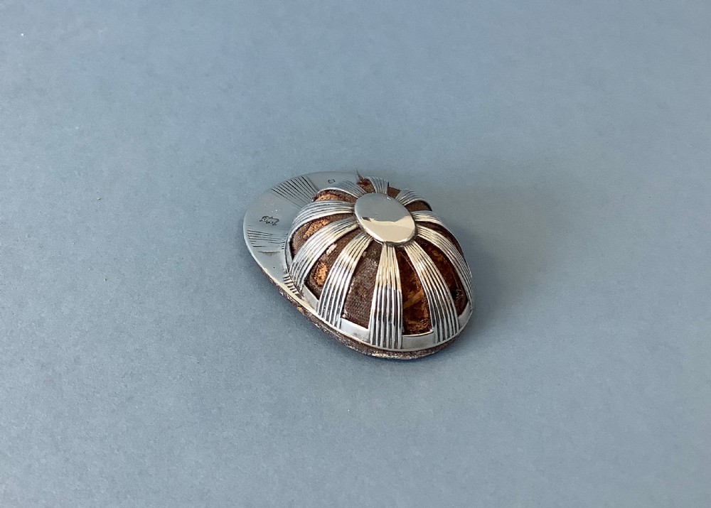 An antique sterling silver pin cushion crafted in the form of a jockey cap with ribbed panels and fabric padding. View III