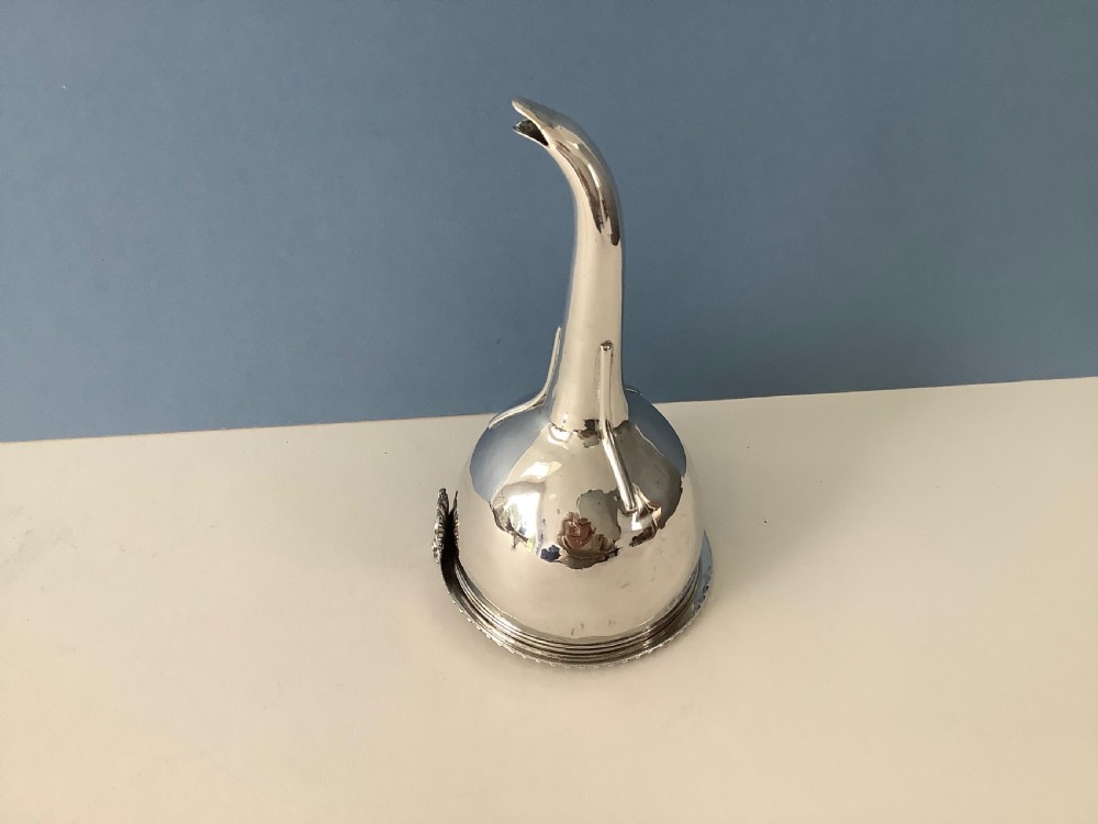 A three-part Georgian solid silver wine funnel featuring a perforated bowl with gadrooned rim, a retaining ring, and a curved spout. View VII