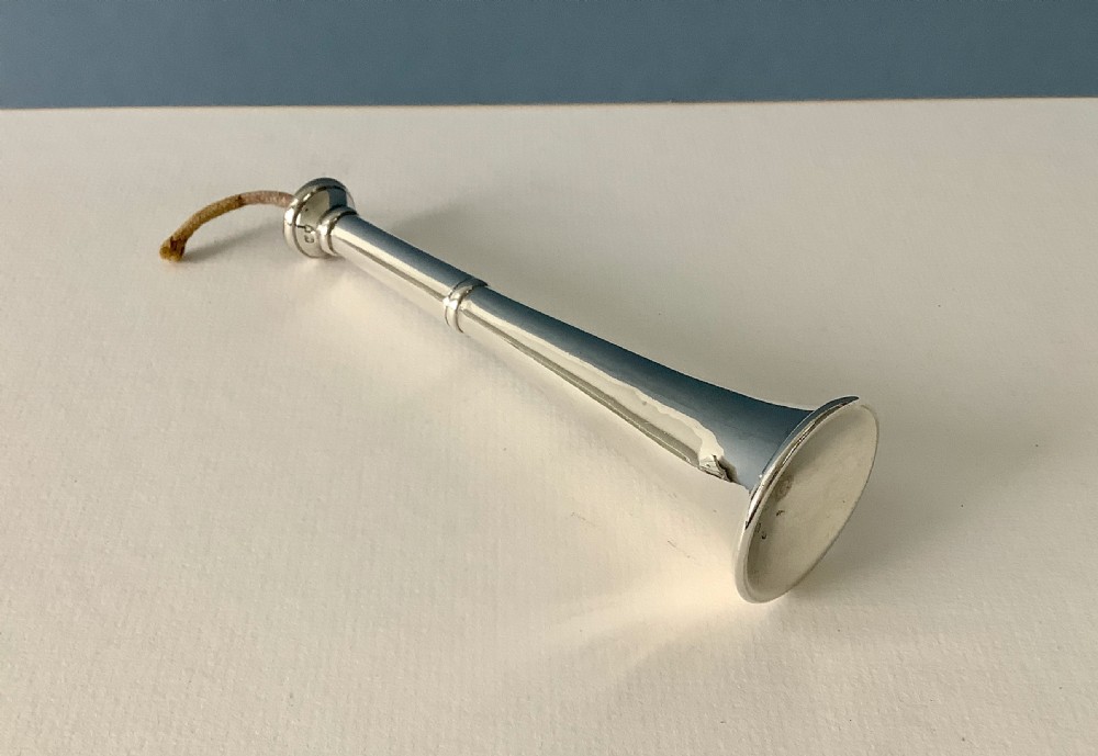 An antique solid silver table lighter designed in the form of a vertical hunting horn with an exposed wick protruding from the top. View II