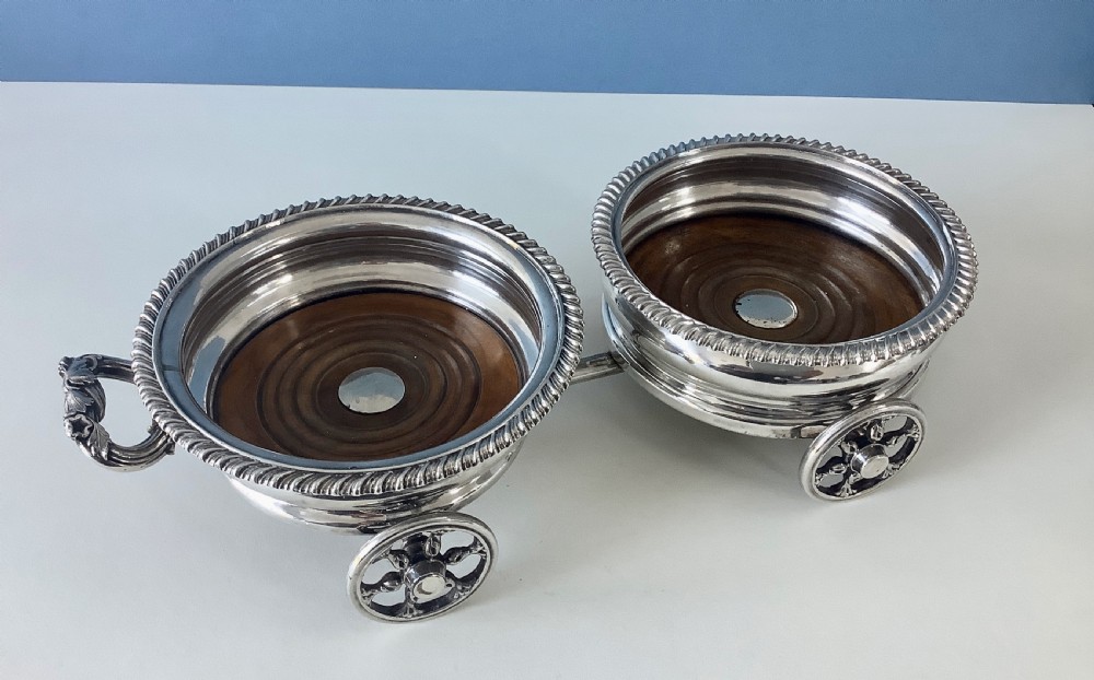 A Georgian Old Sheffield Plate double wine coaster trolley featuring two gadrooned circular holders joined on a wheeled frame with a small end handle. View III