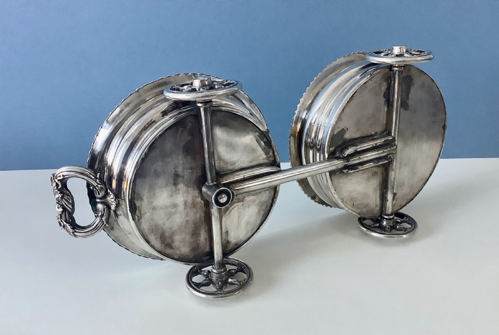 A Georgian Old Sheffield Plate double wine coaster trolley featuring two gadrooned circular holders joined on a wheeled frame with a small end handle. View VI