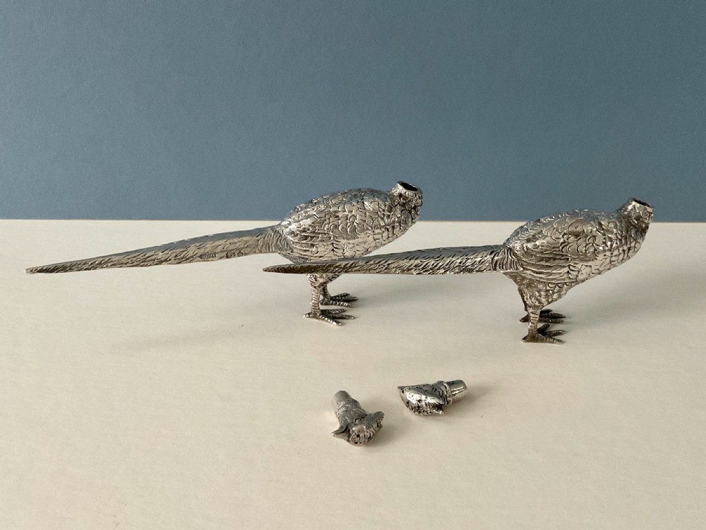 A pair of detailed solid silver pepper shakers crafted in the form of standing pheasants with long tail feathers. View II