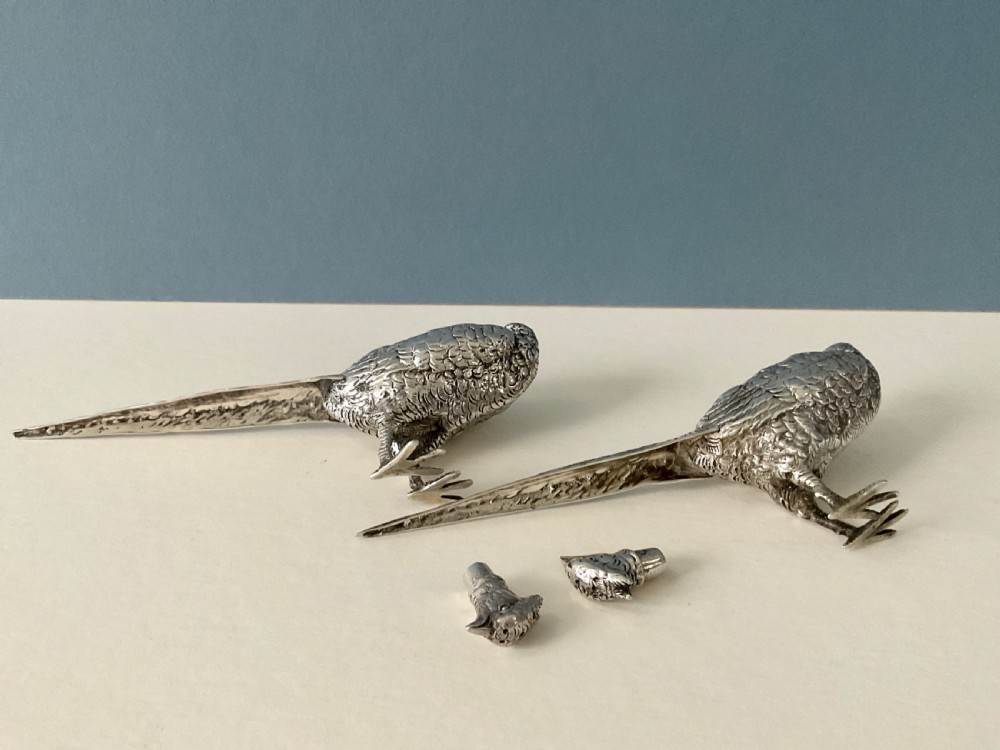 A pair of detailed solid silver pepper shakers crafted in the form of standing pheasants with long tail feathers. View VI