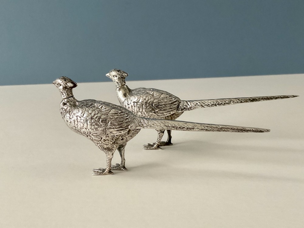 A pair of detailed solid silver pepper shakers crafted in the form of standing pheasants with long tail feathers. View VIII