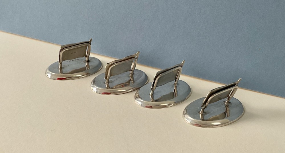 A set of four Edwardian silver and colourful enamel flag menu holders housed within a fitted brown presentation box. View III