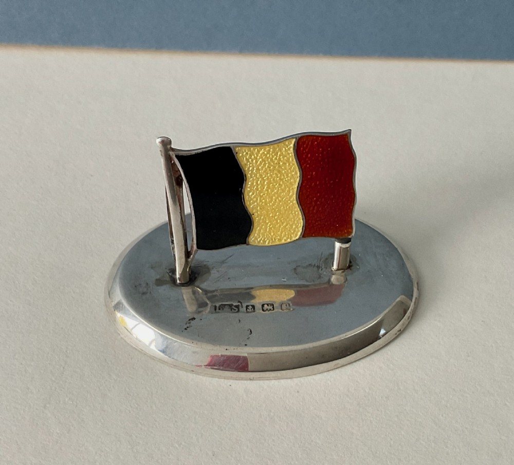 A set of four Edwardian silver and colourful enamel flag menu holders housed within a fitted brown presentation box. View VI