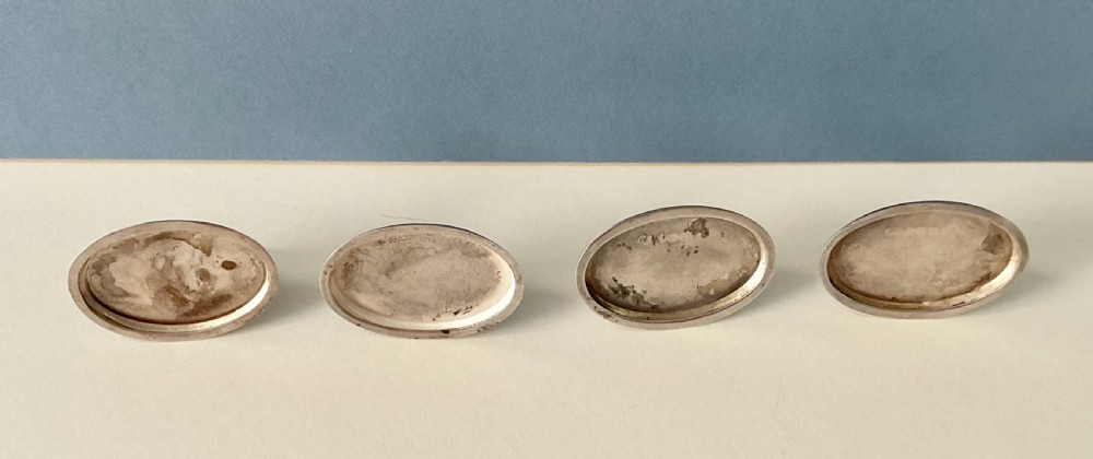 A set of four Edwardian silver and colourful enamel flag menu holders housed within a fitted brown presentation box. View VII