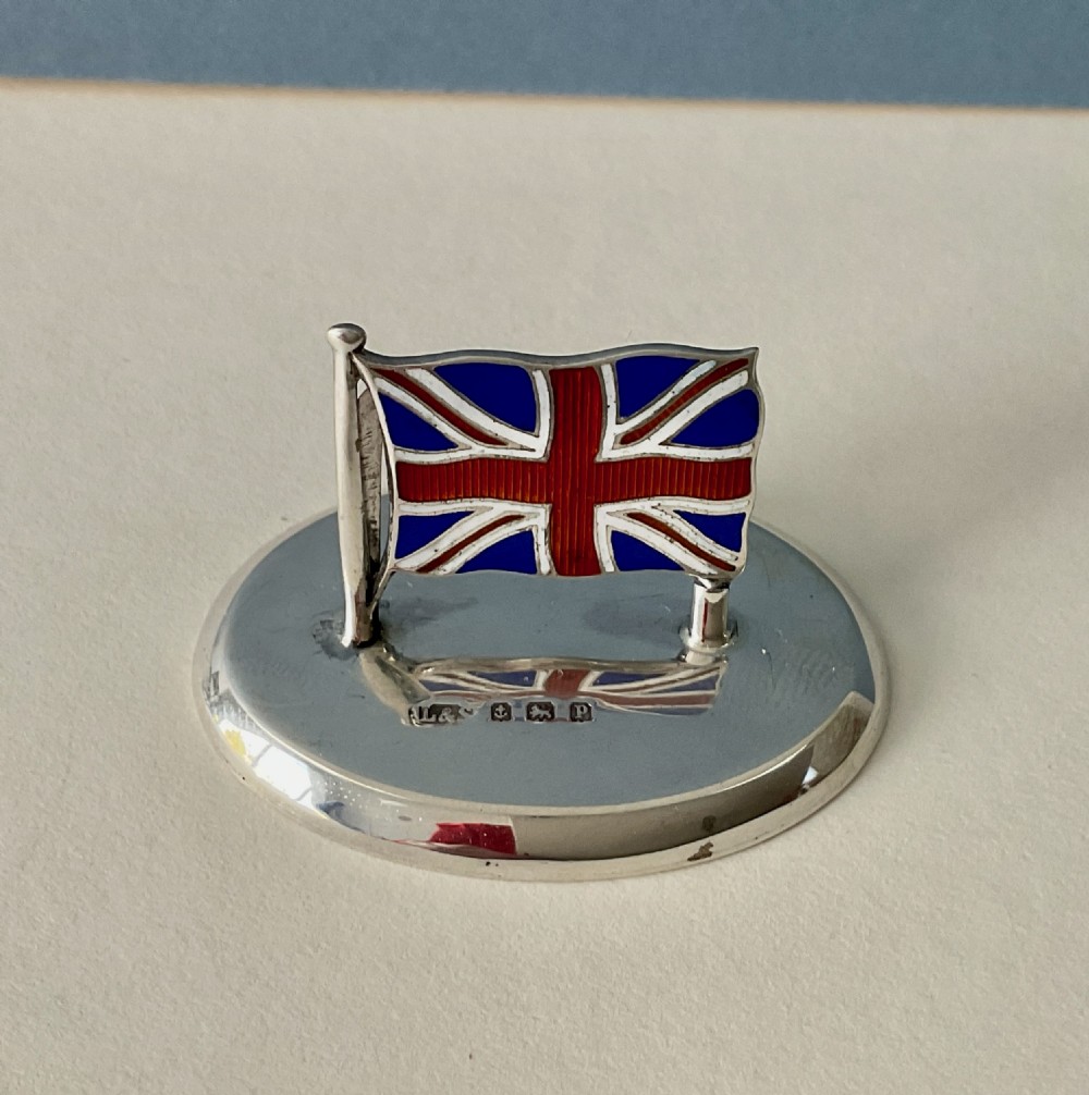 A set of four Edwardian silver and colourful enamel flag menu holders housed within a fitted brown presentation box. View VIII