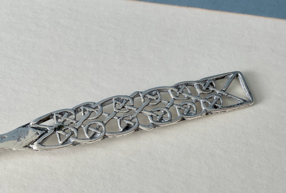 An Arts and Crafts sterling silver spoon with an oval bowl and an intricate pierced Celtic knotwork handle. View III