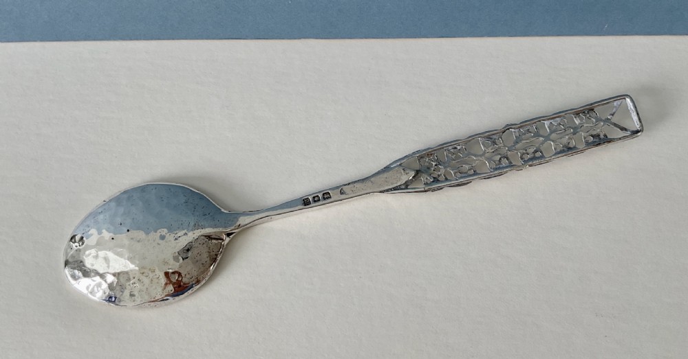 An Arts and Crafts sterling silver spoon with an oval bowl and an intricate pierced Celtic knotwork handle. View VII