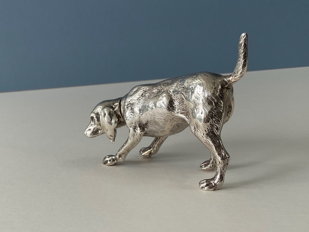 A solid silver novelty pepper pot cast in the detailed form of a standing hunting dog. View II