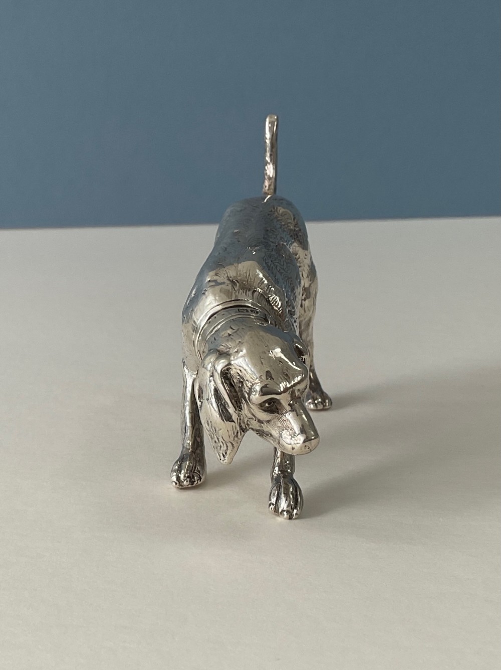 A solid silver novelty pepper pot cast in the detailed form of a standing hunting dog. View V