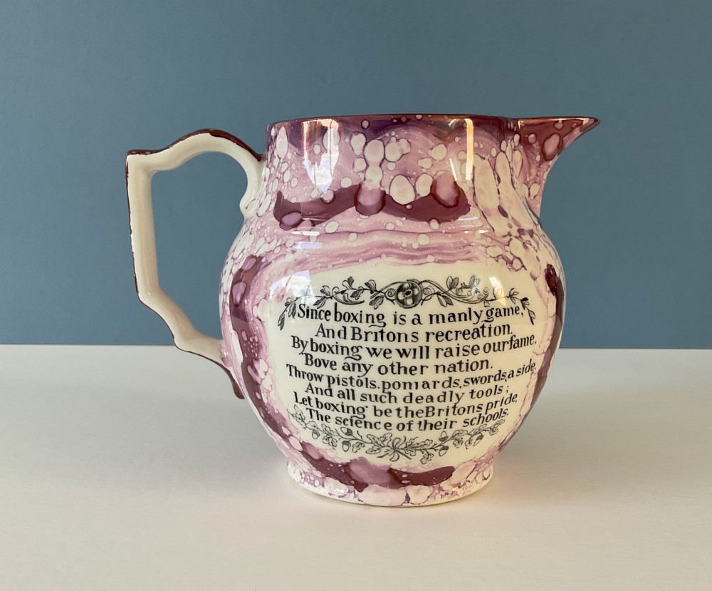 A 19th-century pink splash Sunderland lustre jug decorated with a transfer print depicting two bare-knuckle boxers in a match stance. View II