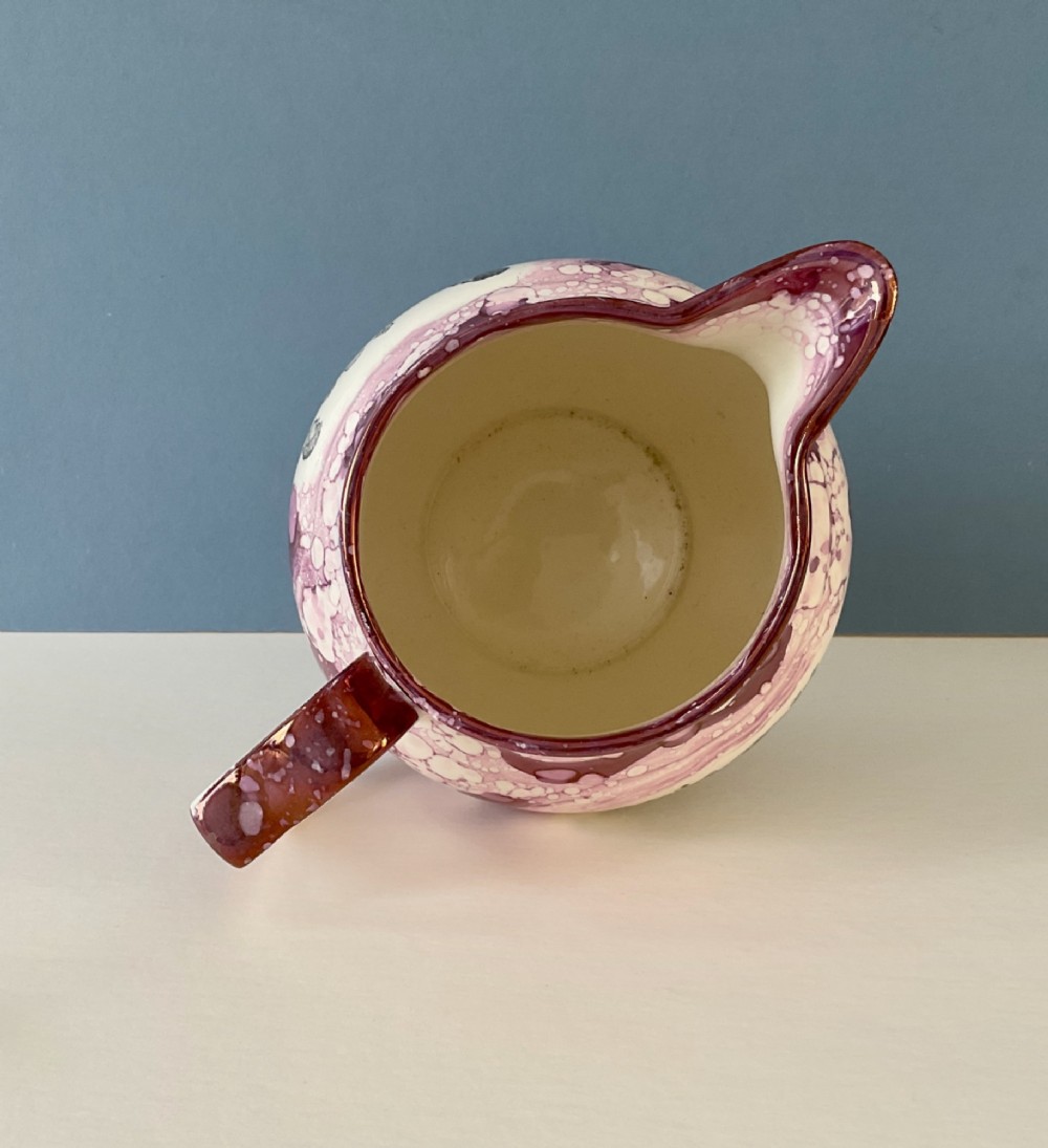 A 19th-century pink splash Sunderland lustre jug decorated with a transfer print depicting two bare-knuckle boxers in a match stance. View VI