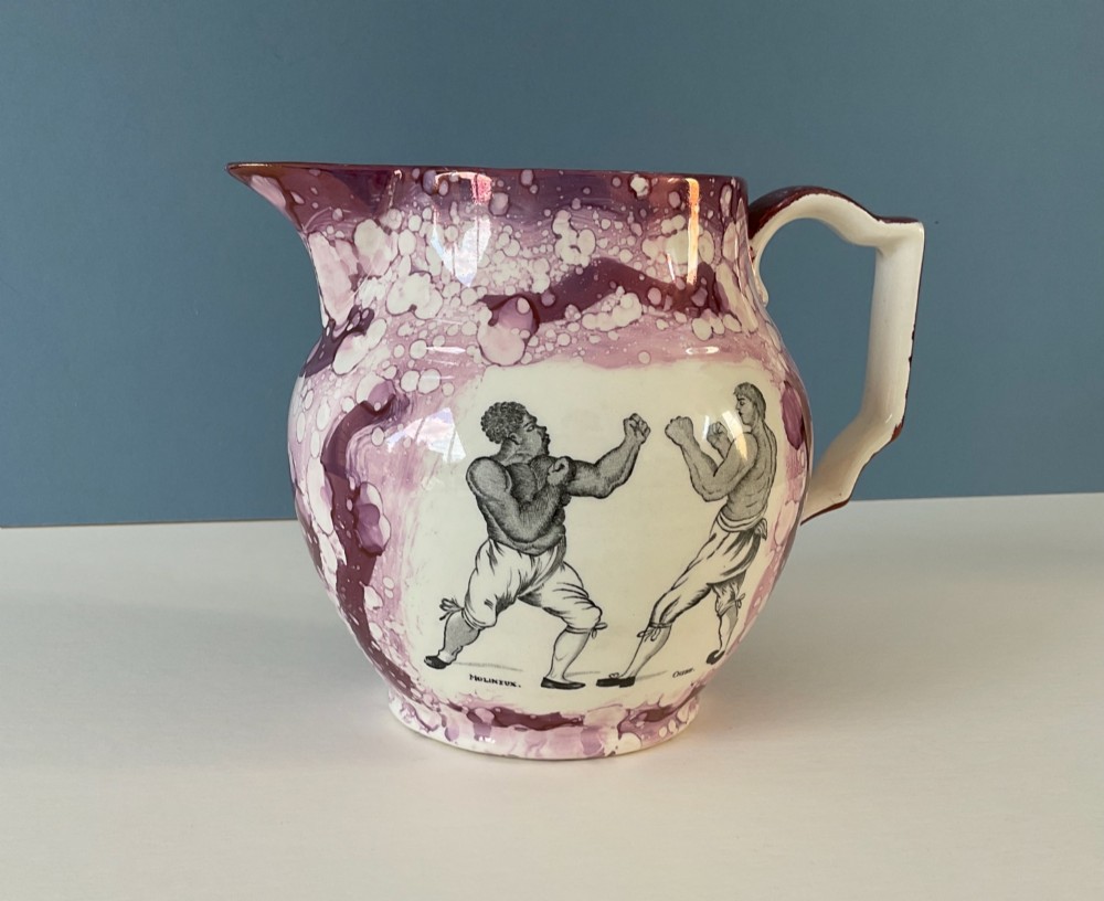 A 19th-century pink splash Sunderland lustre jug decorated with a transfer print depicting two bare-knuckle boxers in a match stance. View IX