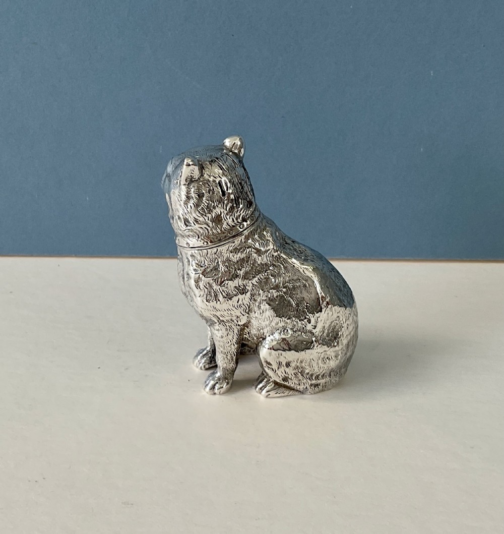 A small silver pepper caster crafted in the form of a seated cat with detailed chased fur and a collar. View VIII