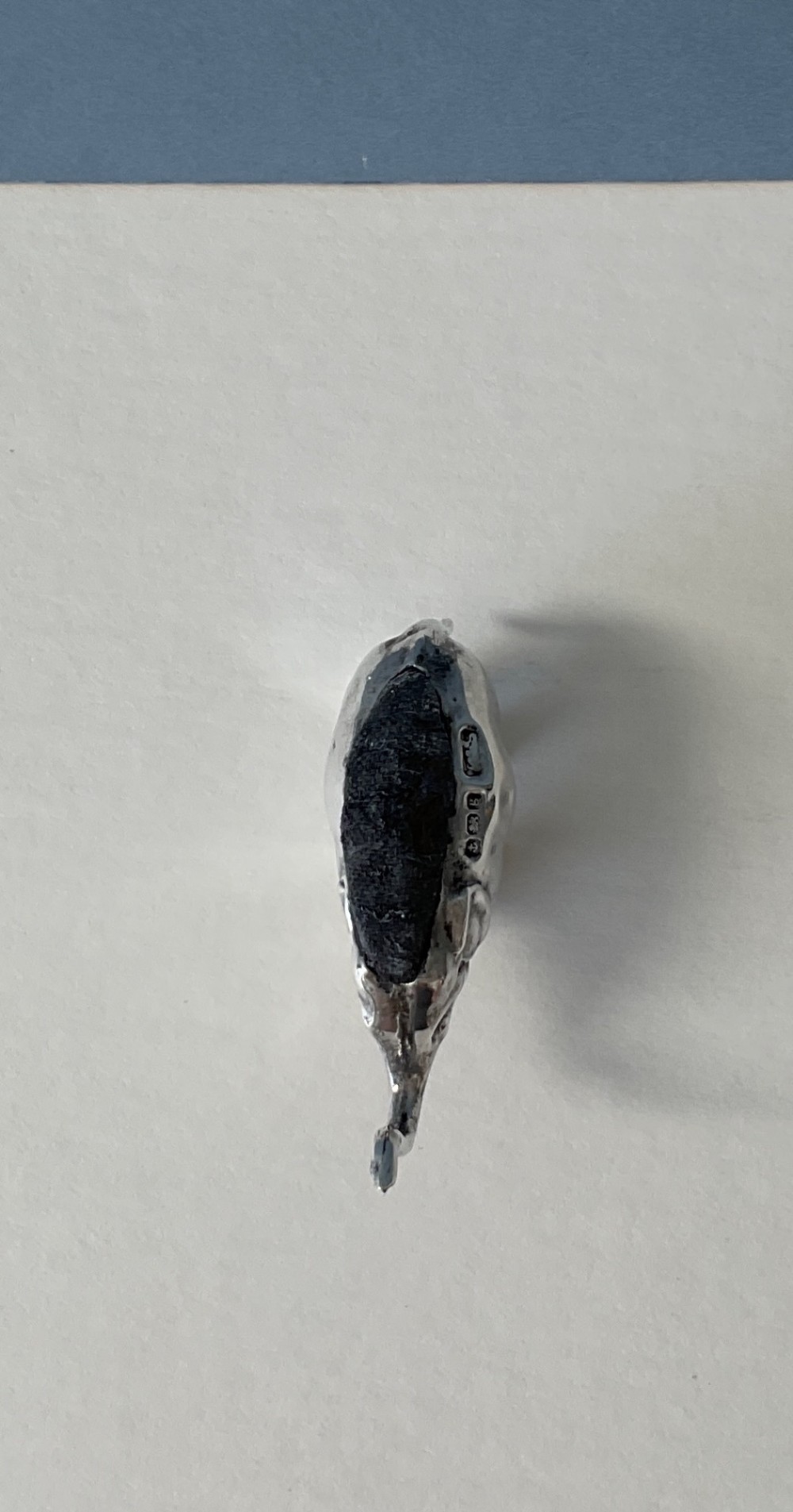 A miniature silver novelty pin cushion cast in the shape of an elephant with a dark fabric insert set into its back. View IV